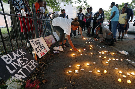 Community members light candles during a vigil for 13-year-old Tyre King Thursday Sept. 15 2016 in Columbus Ohio. King was shot and killed by Columbus police Wednesday evening