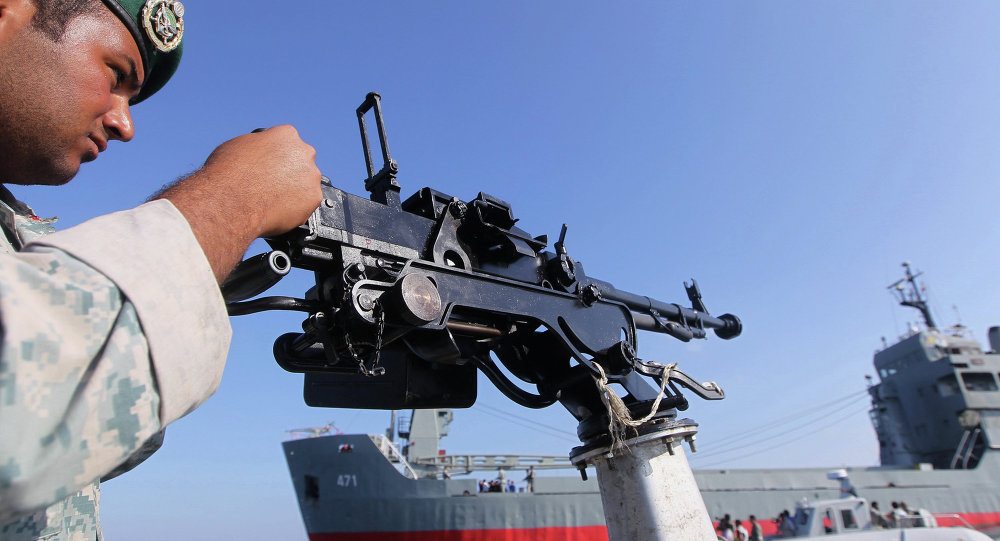 An Iranian Army soldier stands guard on a military speed boat during the Velayat-90 navy exercises in the Strait of Hormuz in southern Iran