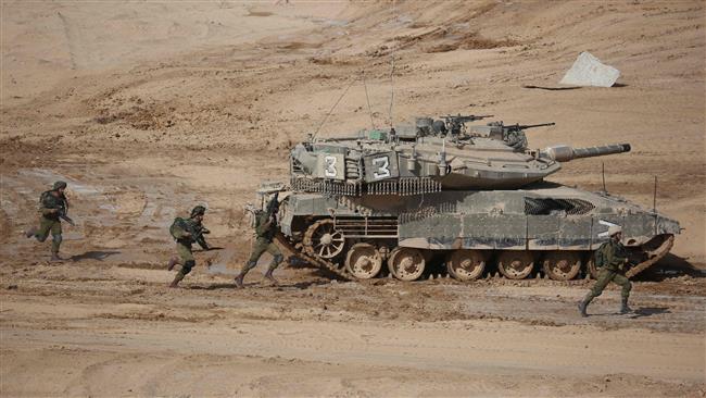 Israeli soldiers run next to a tank in the Negev desert