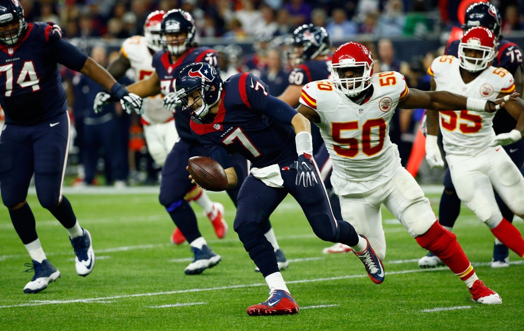 HOUSTON TX- JANUARY 09 Quarterback Brian Hoyer #7 of the Houston Texans scrambles against Justin Houston #50 of the Kansas City Chiefs in the third quarter during the AFC Wild Card Playoff game at NRG Stadium