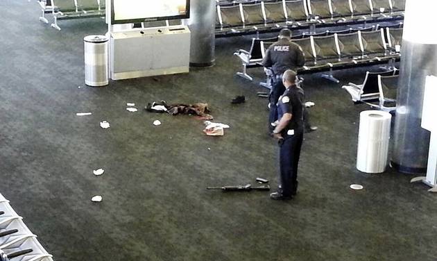 AP which has been authenticated based on its contents and other AP reporting police officers stand near a weapon inside Terminal 2 at Los Angeles International Airport after a gunman opened fire