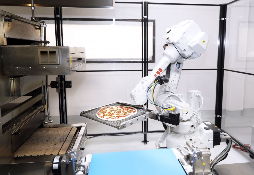 Pizza Making Robots-3 A robot places a pizza into an oven at Zume Pizza in Mountain View Calif