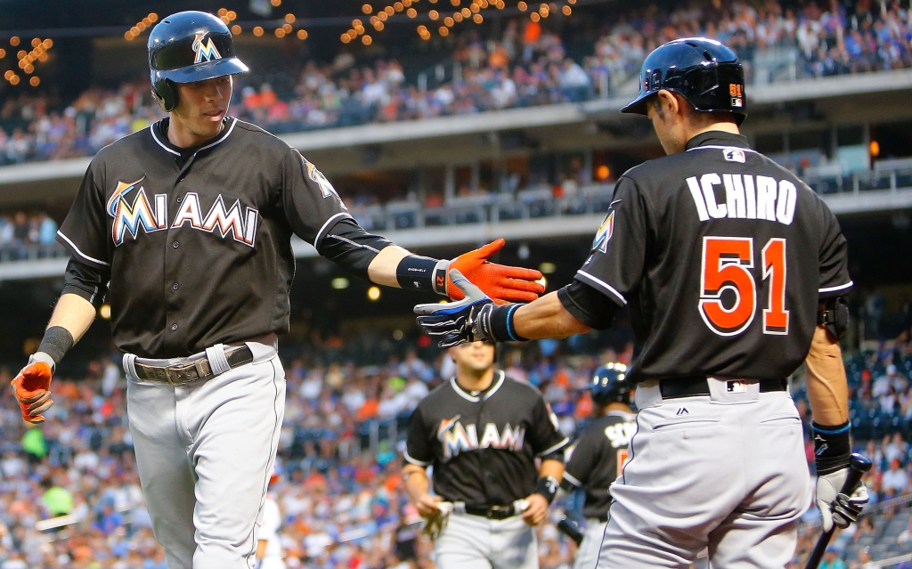 Christian Yelich #21 of the Miami Marlins celebrates his first inning two run home run against the New York Mets with teammate Ichiro Suzuki #51 at Citi Field