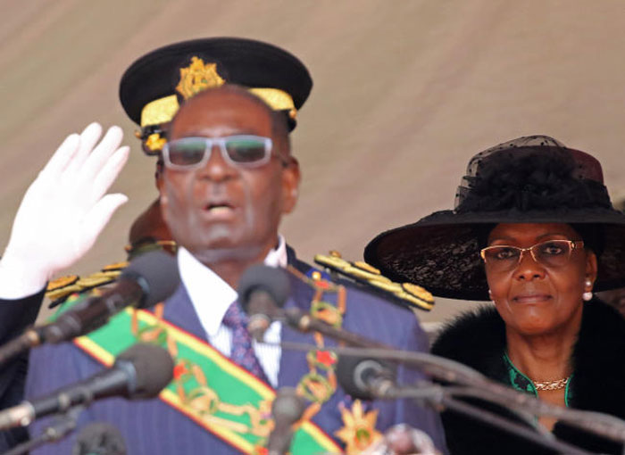 Zimbabwe President Robert Mugabe left and his wife Grace look on during the Defense Force’s 36th Anniversary celebrations in the capital Harare Zimbabwe in this file