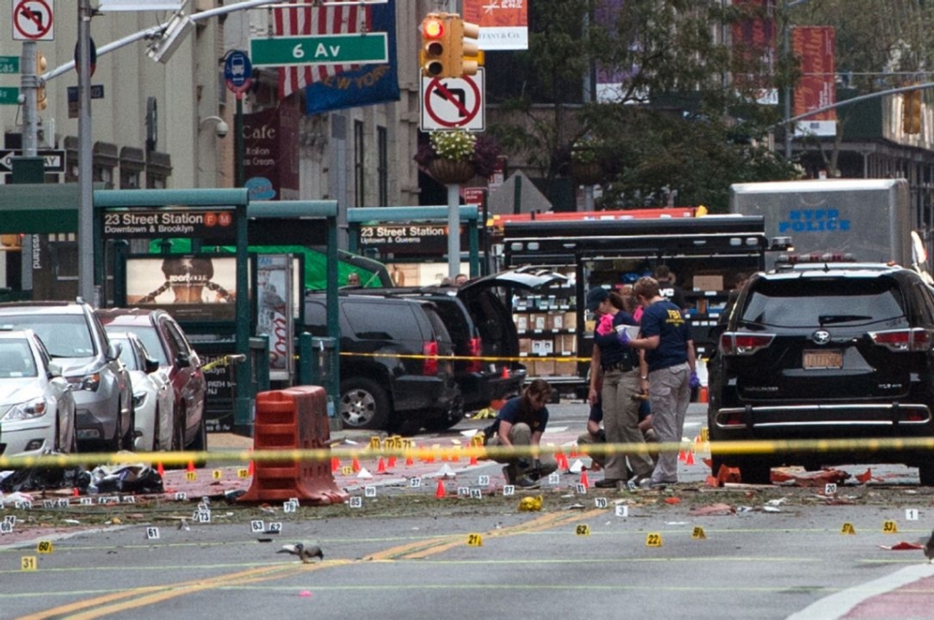 FBI agents review the crime scene of remnants of bomb debris on 23rd St. in Manhattan's Chelsea neighborhood on Sept.18. The explosion prompted authorities to warn the public about suspect Ahmad Khan Rahami with a mobile phone alert