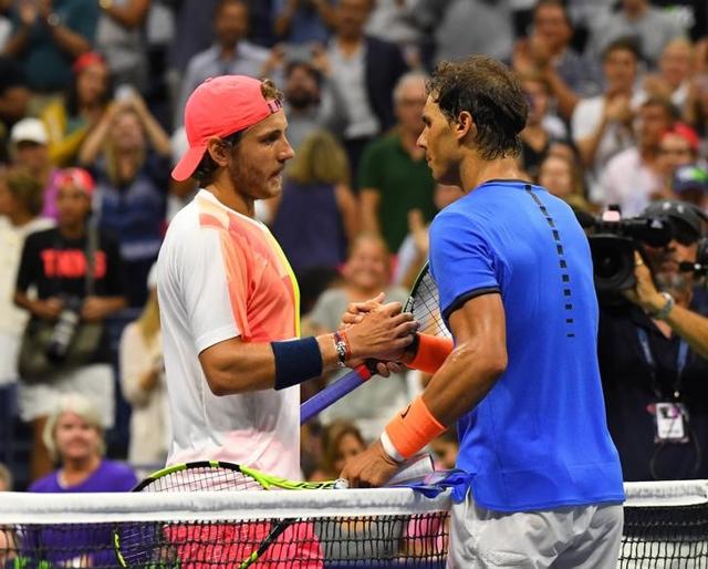 Nadal and Pouille shake hands at the net after the match