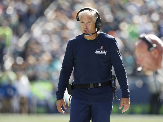 Seattle Seahawks head coach Pete Carroll walks the sidelines during the first quarter against the Miami Dolphinsat Century Link Field