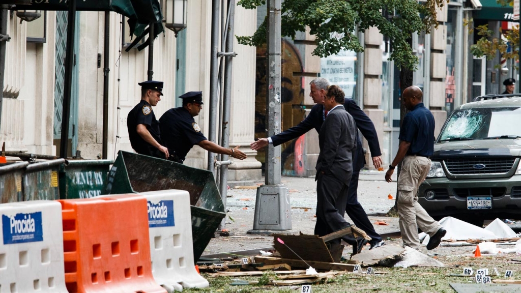 New York Mayor Bill de Blasio and New York Governor Andrew Cuomo greet officers at the site of an explosion that occurred in the Chelsea neighborhood of New York