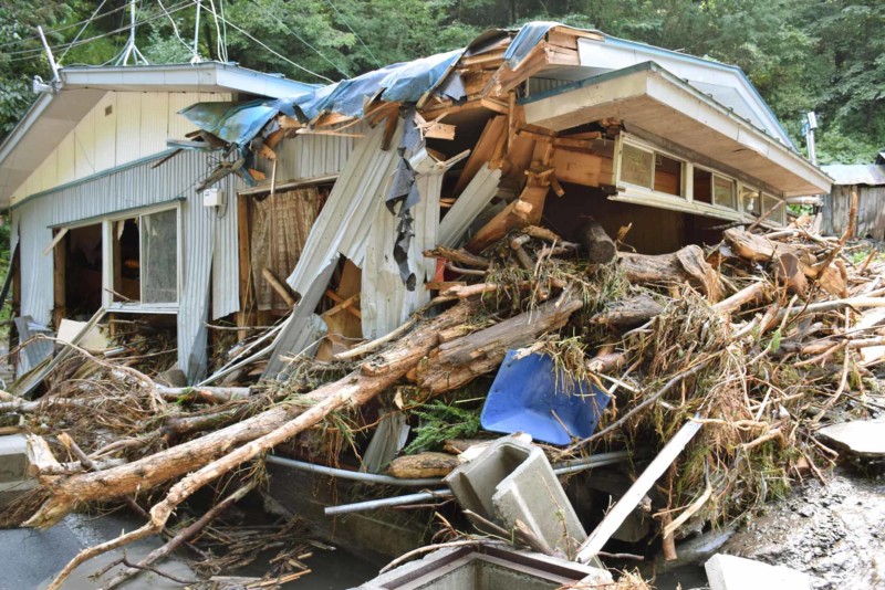 A residential house is damaged by driftwood in Kuji city Iwate prefecture northern Japan Wednesday Aug. 31 2016. Typhoon Lionrock hit the northern Japan dumping heavy rains