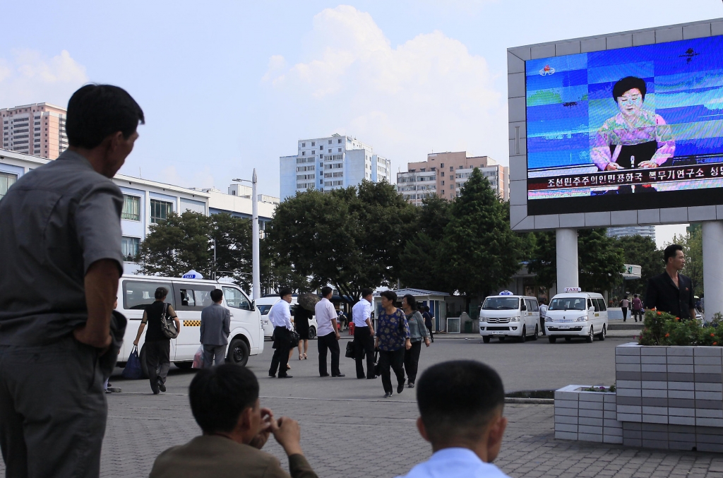 North Koreans watch a news report regarding a nuclear test on a large screen outside the Pyongyang Station in Pyongyang North Korea Friday Sept. 9 2016. North Korea said Friday it conducted a'higher level nuclear warhead test explosion which it tru