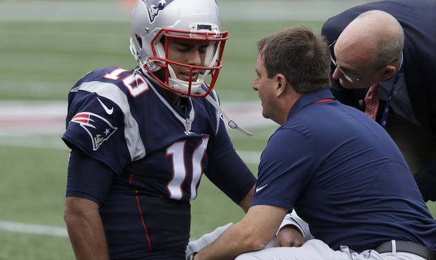 New England Patriots quarterback Jimmy Garoppolo receives attention after an injury during the first half of an NFL football game against the Miami Dolphins Sunday Sept. 18 2016 in Foxborough Mass