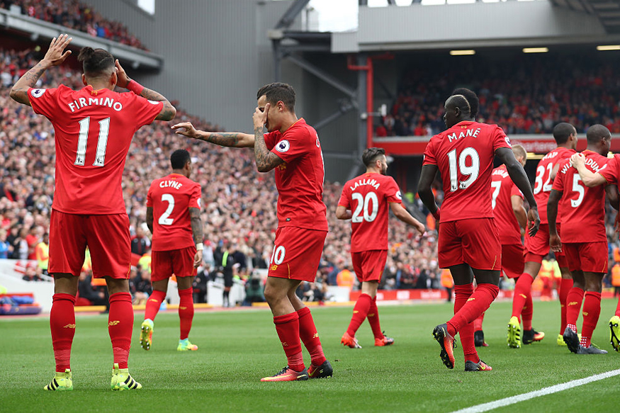 Philippe Coutinho celebrates with Roberto Firmino as Liverpool scores their fourth goal during the match against Hull City at Anfield