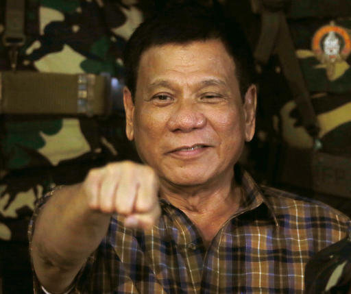 Philippine President Rodrigo Duterte gestures with a fist bump during his visit to the Philippine Army's Camp Mateo Capinpin at Tanay township Rizal province east of Manila Philippines Wednesday Aug. 24 2016. President Duterte's threat to withdraw the