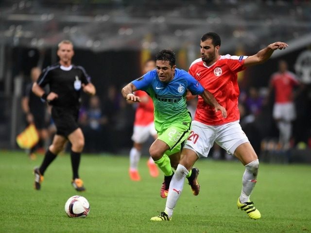 MILAN ITALY- SEPTEMBER 15  Citadin Eder of FC Internazionale competes for the ball with Loai Taha of Hapoel Beer Sheva FC during the UEFA Europa League match between FC Internazionale Milano and Hapoel Beer Sheva FC at Stadio Giuseppe Meazza on Se