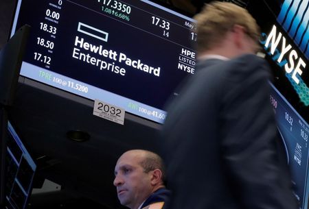 A trader passes by the post where Hewlett Packard Enterprise Co. is traded on the floor of the New York Stock Exchange