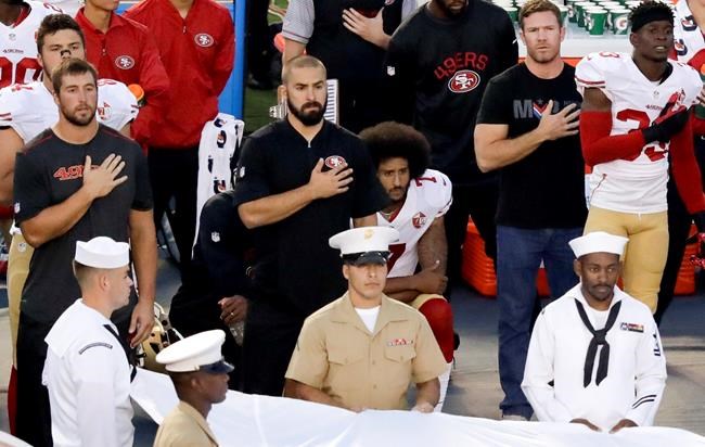 San Francisco 49ers quarterback Colin Kaepernick center kneels during the national anthem before an NFL preseason football game against the San Diego Chargers in San Diego. With Case Keenum and Blaine