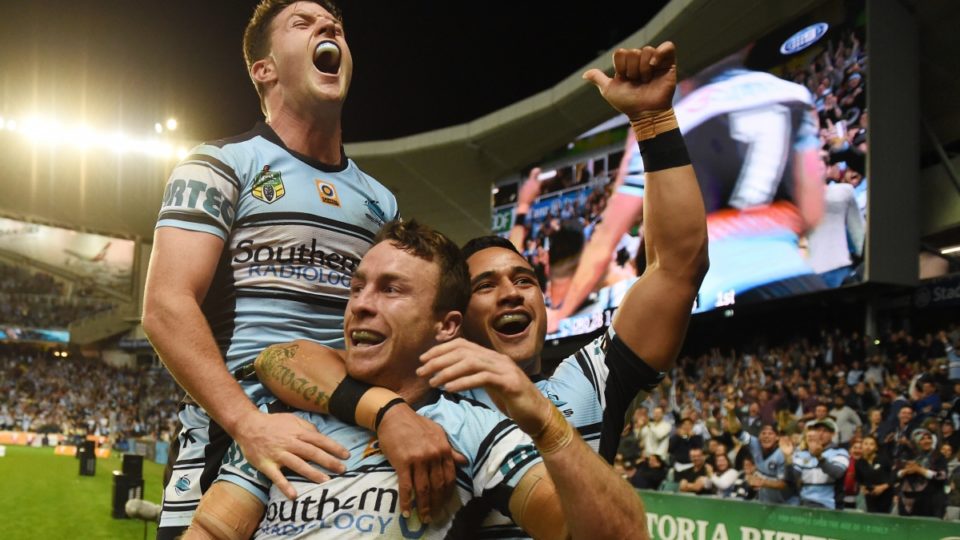 Cronulla's James Maloney celebrates his run-away try with Chad Townsend and Valentine Holmes during the NRL preliminary final against North Queensland