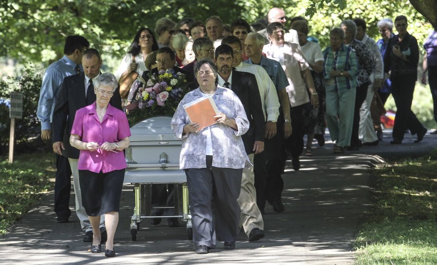 The casket containing the remains of Sister Paula Merrill leads the processional into the cemetery following her funeral service Friday at St. Vincent Church in Bardstown Ky. Sister Merrill with the Sisters of Charity of Nazareth and another nun were