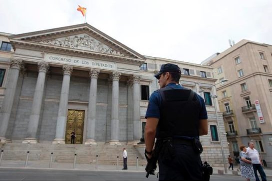 A police officer stands guard in front of the Spanish Parliament in Madrid Spain Tuesday Aug. 30 2016. Spain's acting Premier Mariano Rajoy is to start a two-day parliamentary debate later Tuesday ahead of a vote on his bid to form a minority governme