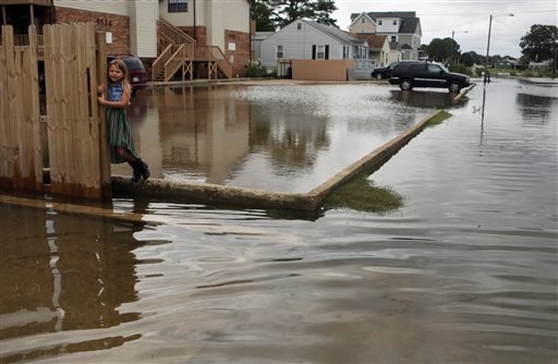 Chloe Riffle 7 watches as she is surrounded by water on Sunday Sept. 4 2016 in the Ocean View section of Norfolk Va. Storm system Hermine spun away from the U.S. East Coast on Sunday removing the threat of heavy rain but maintaining enough power