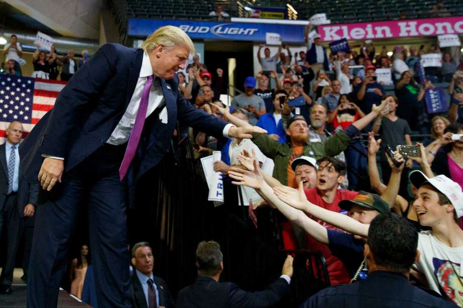 Republican presidential candidate Donald Trump shakes hands as he arrives to a campaign rally at Xfinity Arena of Everett Tuesday Aug. 30 2016 in Everett Wash