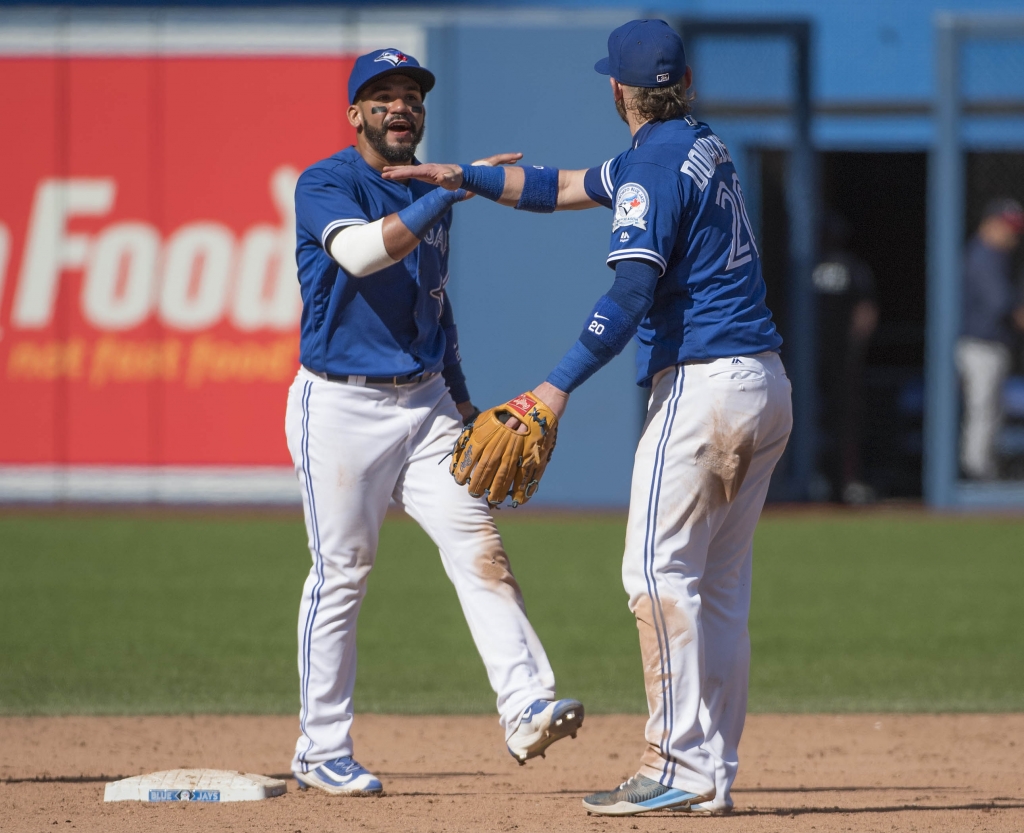 Aug 27 2016 Toronto Ontario CAN Toronto Blue Jays third baseman Josh Donaldson celebrates with second baseman Devon Travis after the game against the Minnesota Twins at Rogers Centre. The Toronto Blue Jays won 8-7. Mandatory Credit Nick Tu