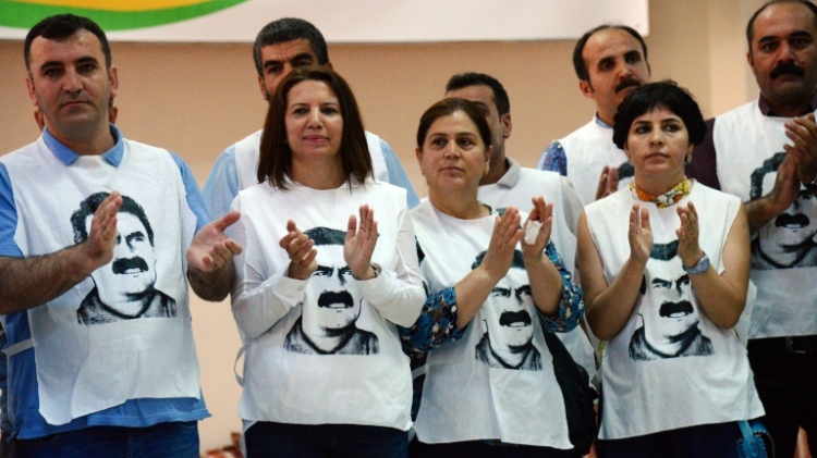 Supporters of Turkey's pro Kurdish People's Democratic Party wear T-shirts featuring jailed PKK leader Abdullah Ocalan at a rally