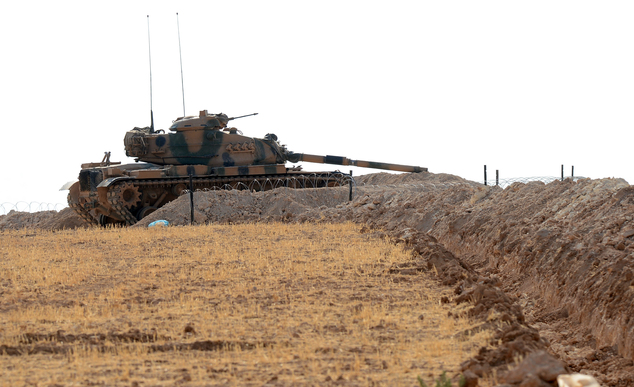 A Turkish tank is stationed near the Syrian border in Karkamis Turkey Monday Aug. 29 2016. Turkey's state-run news agency says three rockets fired from