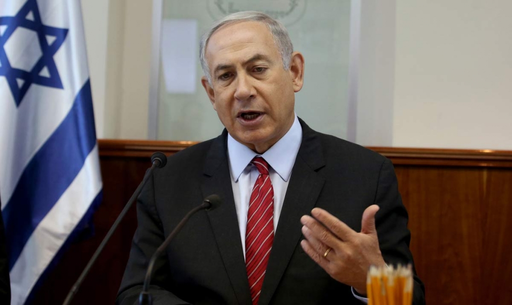 Israeli Prime Minister Benjamin Netanyahu gestures as he opens the weekly cabinet meeting at his Jerusalem office