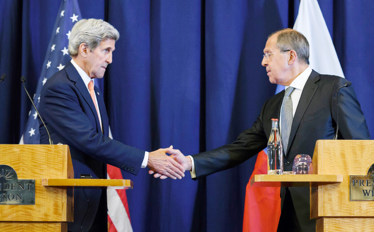 US Secretary of State John Kerry and Russian Foreign Minister Sergei Lavrov shake hands at the end of a press conference in Geneva on Friday. — AFP