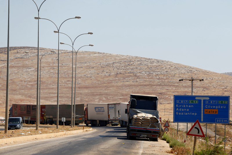 Commercial Turkish trucks wait to cross to Syria near the Cilvegozu border gate located opposite the Syrian commercial crossing point Bab al Hawa in Reyhanli Hatay province Turkey