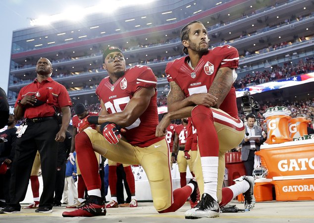 San Francisco 49ers safety Eric Reid and quarterback Colin Kaepernick kneel during the national