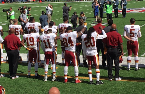 Washington Redskins players raise their fists during the national anthem at the Sept. 25 2016 game against the New York Giants