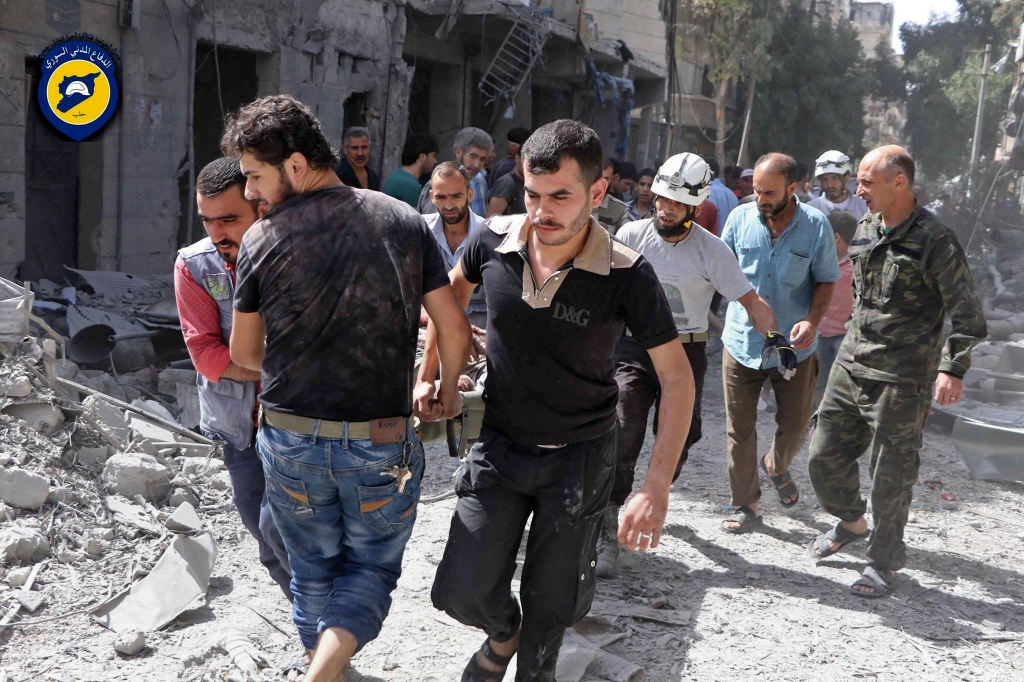 White Helmet rescue volunteers work at the site of airstrikes in the rebel-held al Mashhad neighborhood in eastern Aleppo on Wednesday