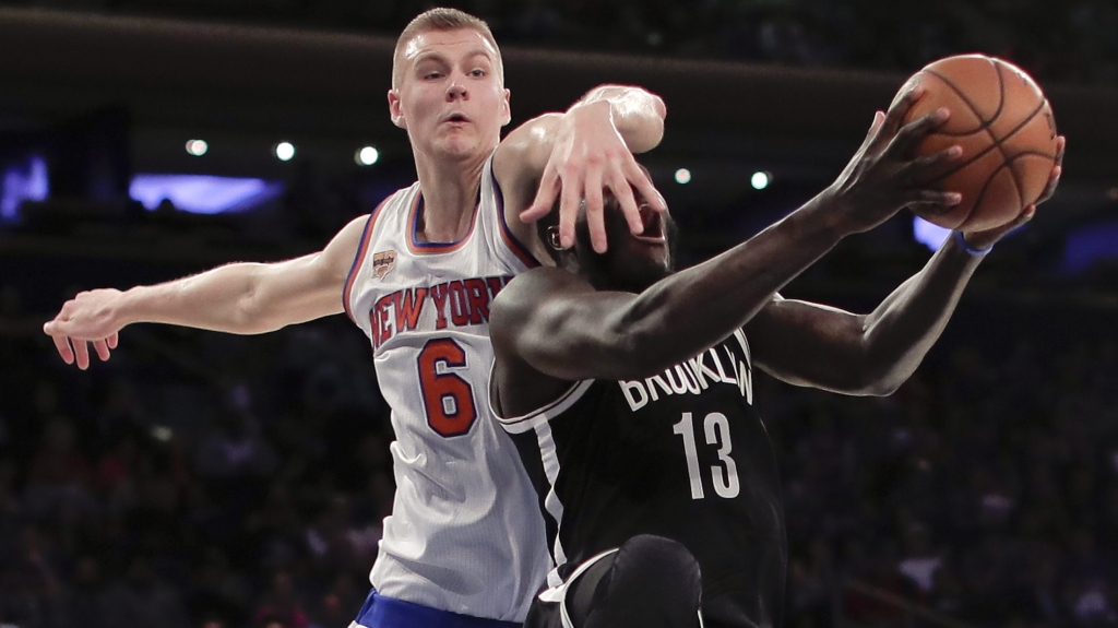 Brooklyn Nets forward Anthony Bennett is fouled by New York Knicks forward Kristaps Porzingis while shooting during the third quarter of a preseason NBA basketball game Saturday Oct. 8 2016 in New York