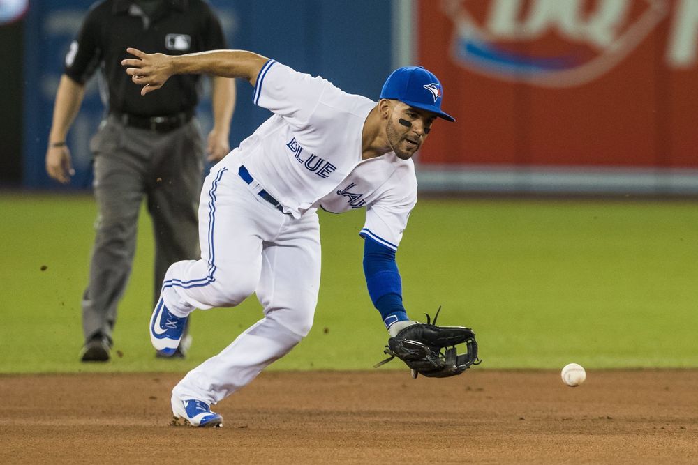 Jays Devon Travis fields a ball by the Baltimore Orioles during the first inning of a baseball game in Toronto. Blue Jays general manager Ross Atkins expects second baseman Devon Travis to return