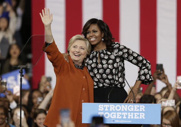 Democratic presidential candidate Hillary Clinton accompanied by first lady Michelle Obama greet supporters during a campaign rally in Winston-Salem N.C