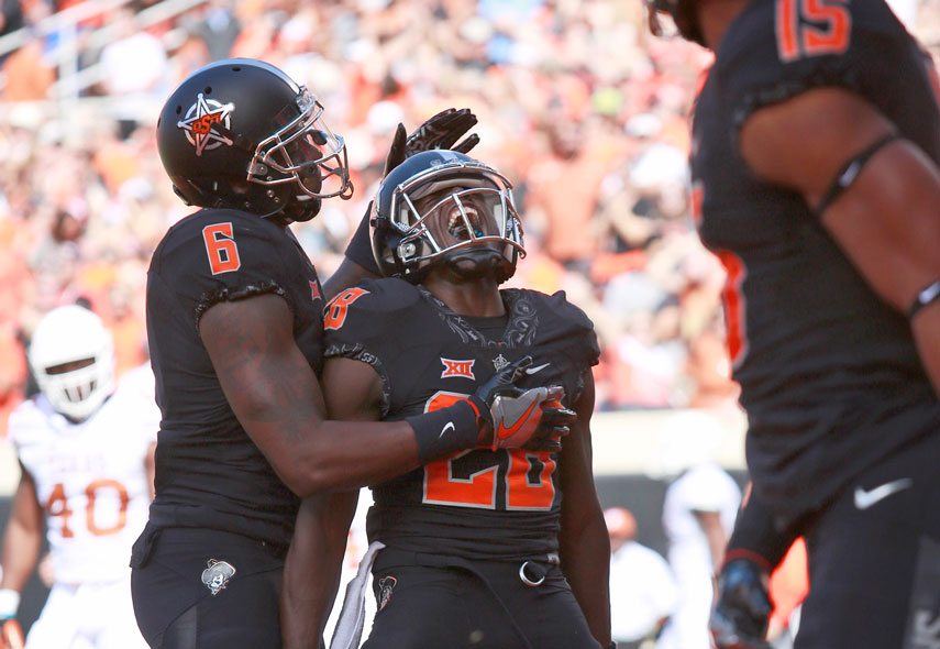 STILLWATER OK- OCTOBER 1: Wide receiver James Washington #28 of the Oklahoma State Cowboys celebrates a touchdown against the Texas Longhorns