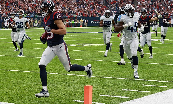 HOUSTON TX- OCTOBER 2 Will Fuller #15 of the Houston Texans returns a punt for 67 yards and a touchdown as Tennessee Titans defenders pursue in the third quarter during the NFL game between the Tennessee Titans and the Houston Texans at NRG Stadium