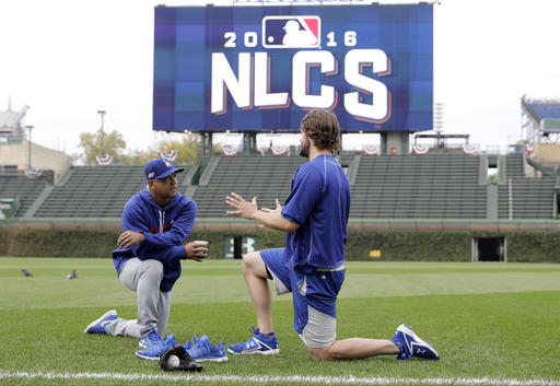 Los Angeles Dodgers manager Dave Roberts left talks to Clayton Kershaw as players warm up before Game 1 of baseball's National League Championship Series against the Chicago Cubs Saturday Oct. 15 2016 in Chicago