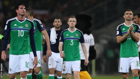 Northern Ireland players show their disappointment after the 2-0 defeat by Germany