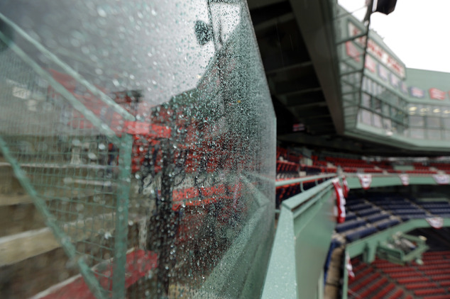 Rain drops cover a glass partition at Fenway Park during steady rain before Game 3 of baseball's American League Division Series between the Cleveland Indian