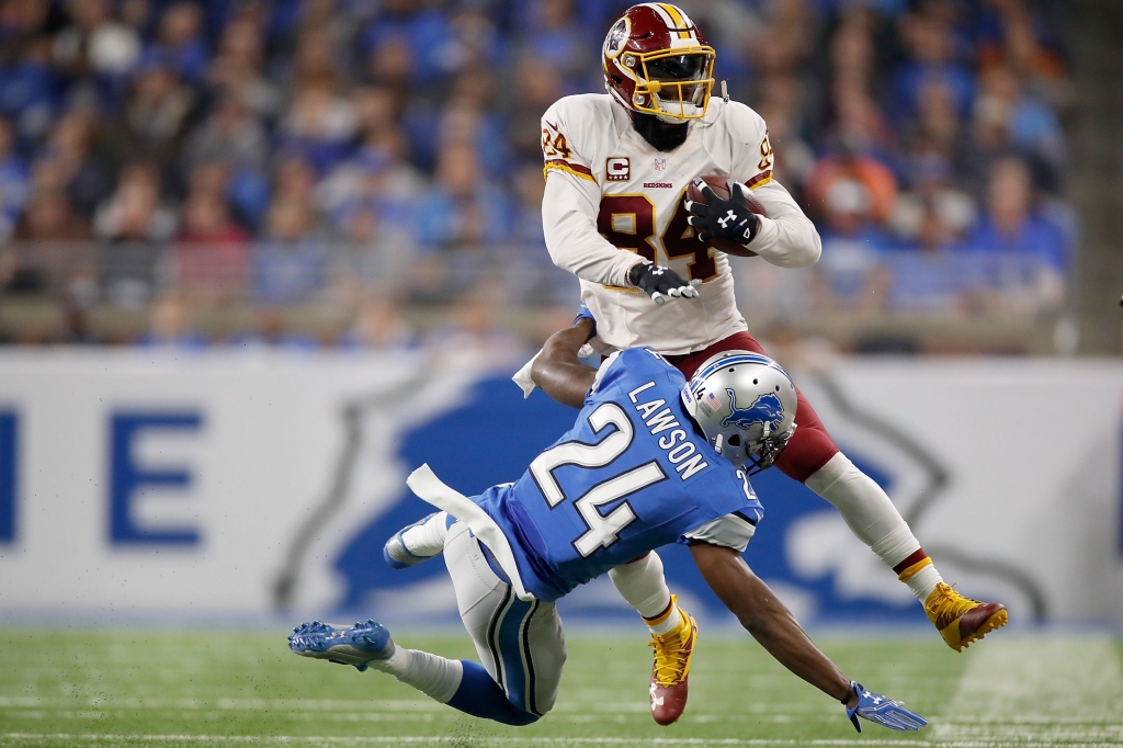 DETROIT MI- OCTOBER 23 Niles Paul #84 of the Washington Redskins runs for yardage against Nevin Lawson #24 of the Detroit Lions during first half at Ford Field