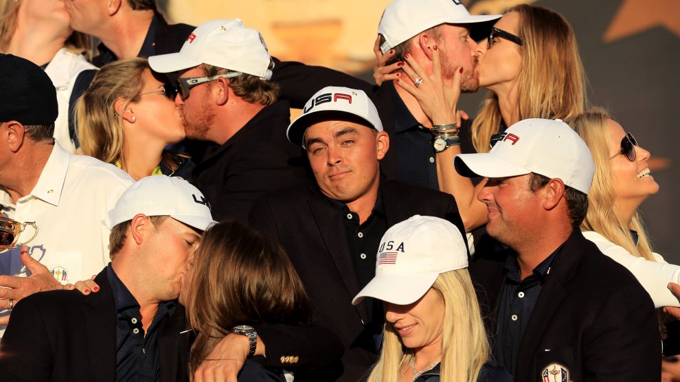 CHASKA MN- OCTOBER 02 Rickie Fowler of the United States looks on as Kim Johnson Zach Johnson J.B. Holmes Erica Holmes Jimmy Walker Erin Walker Jordan Spieth Annie Verret Justine Reed and Patrick Reed celebrate during singles matches of the 20