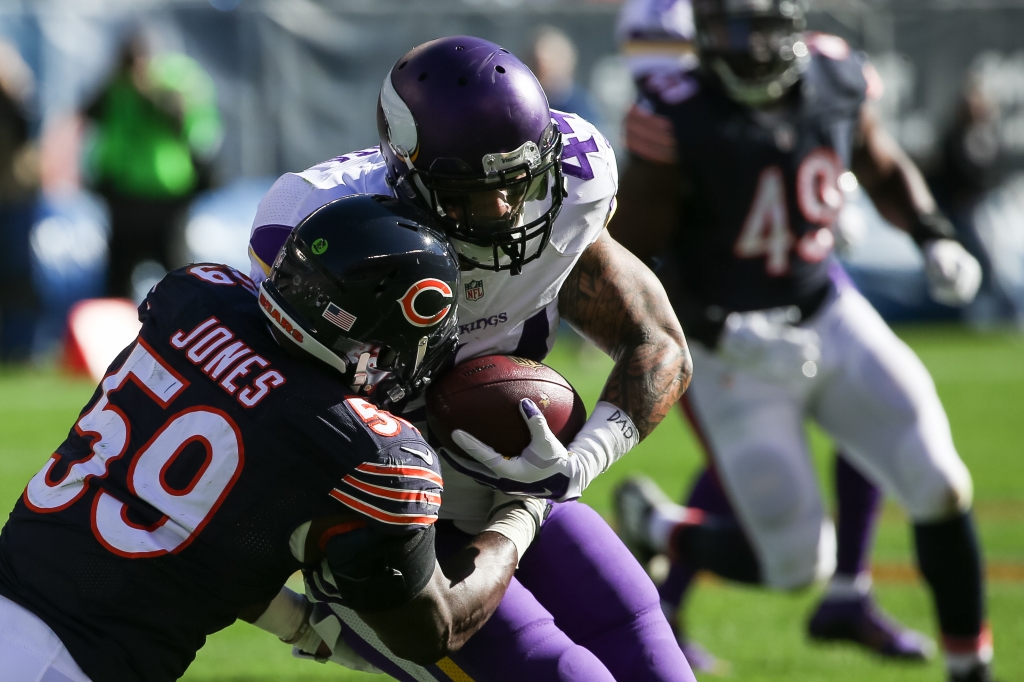 CHICAGO IL- NOVEMBER 01 Matt Asiata #44 of the Minnesota Vikings carries the football against Christian Jones #59 of the Chicago Bears in the second quarter at Soldier Field