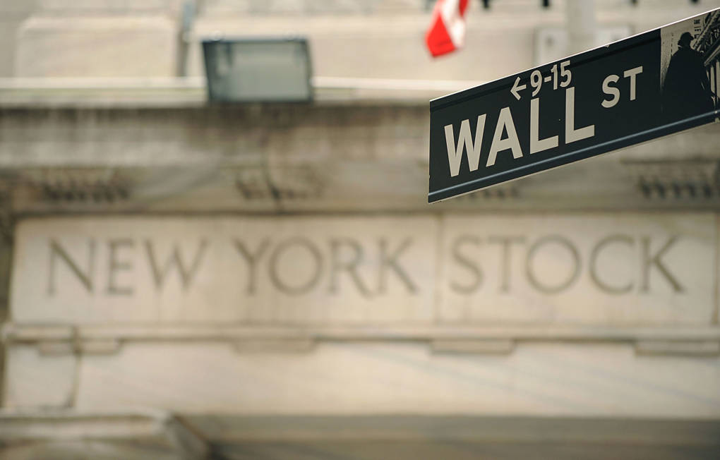 A Wall Street sign outside an entrance of the New York Stock Exchange