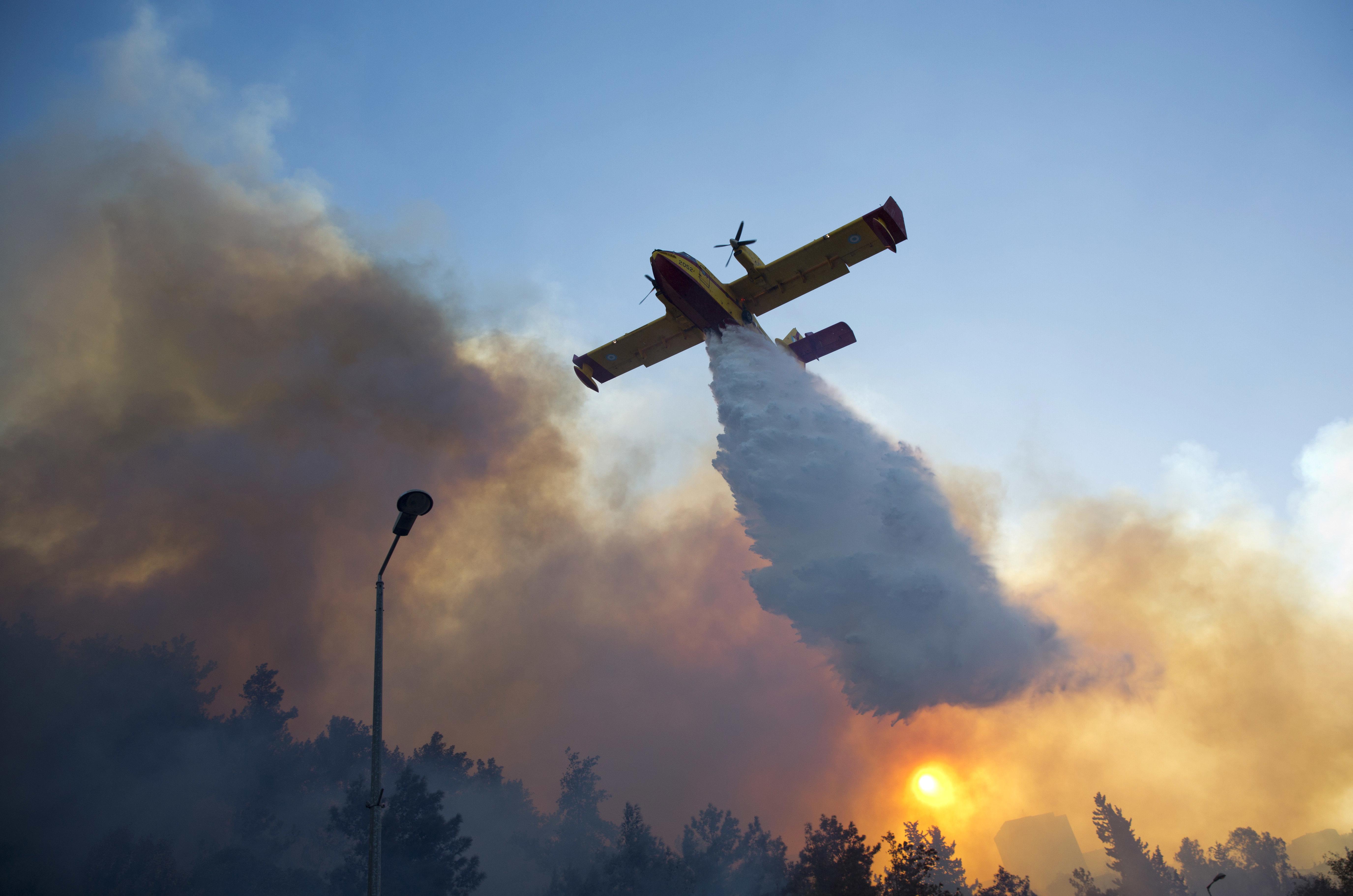 A firefighting plane from Greece fights a wildfire over Haifa Israel Thursday Nov. 24 2016