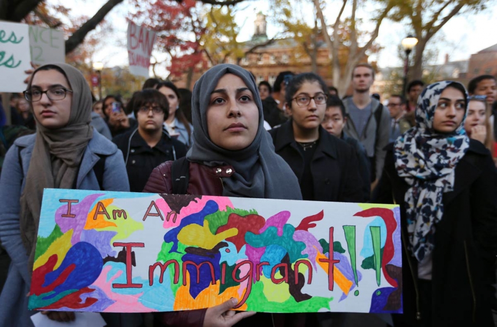 A student holds a sign as she joins a large crowd gathered to protest some of President elect Donald Trump policies and to ask school officials to denounce his plans at Rutgers University Wednesday Nov. 15 2016 in New Brunswick N.J. (AP