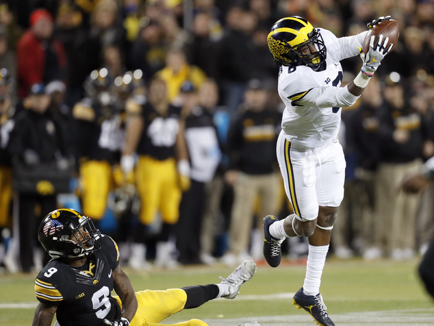 Michigan cornerback Channing Stribling right intercepts a pass intended for Iowa wide receiver Jerminic Smith left during the second half of an NCAA coll