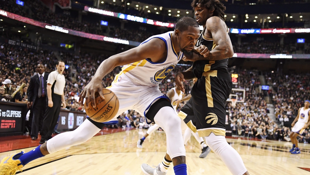 Golden State Warriors forward Kevin Durant drives against Toronto Raptors center Lucas Nogueira during the second half of an NBA basketball game Wednesday Nov. 16 2016 in Toronto